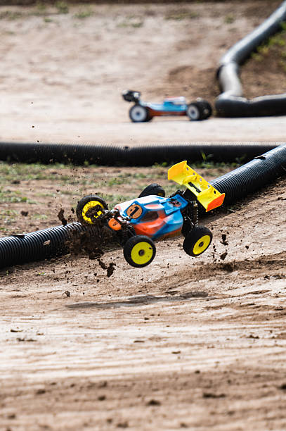 istock Radio-controlled car jumping on dirt track during race 2236381241