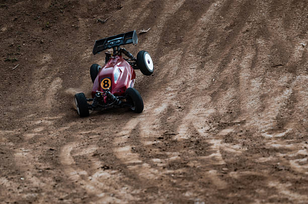 istock Radio-controlled car drifting on dirt track raising dust 2236381266
