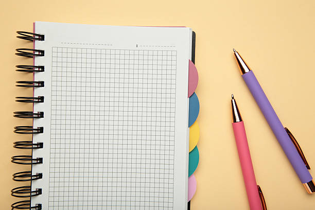 istock Notebook with colorful pens on beige background. 2236385037