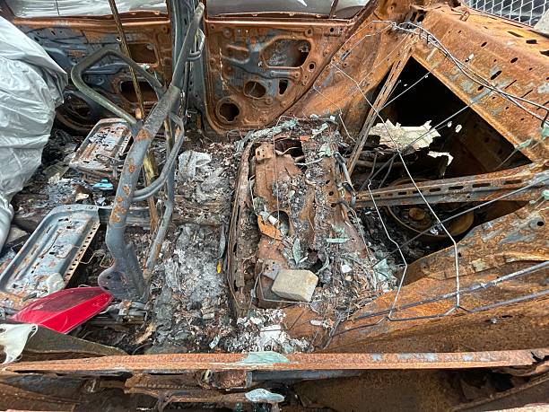 istock burnt car interior with rusted frame and debris after fire 2236386363