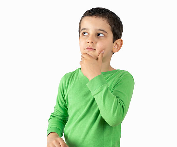 istock Little boy looking pensive over white background 2236386603