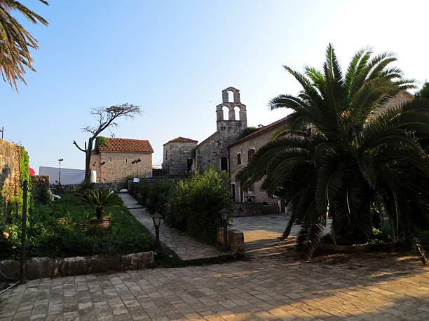 istock Stone church buildings with cobbled pavement and palm trees 2236391278