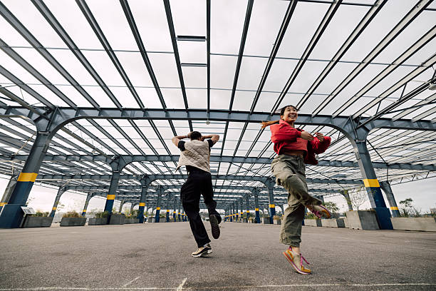 Two friends find joy in an unexpected place, turning an empty steel-framed structure into their dance floor. Their carefree moves capture the spirit of friendship, freedom, and rhythm against a modern urban backdrop.