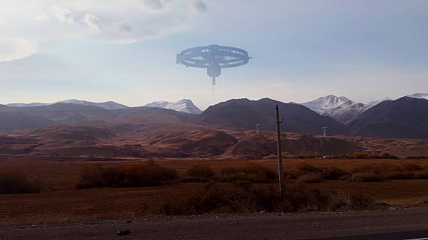 istock A large circular UFO hovers silently above the snow-dusted mountain range in a vast open valley. 2236393062