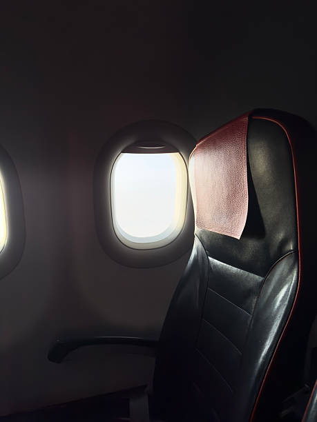istock An airplane seat is bathed in soft light from the nearby window mid-flight. 2236393269