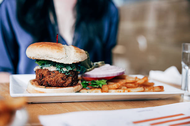 Tempeh And Kale Sandwich With Chili Coleslaw On Table