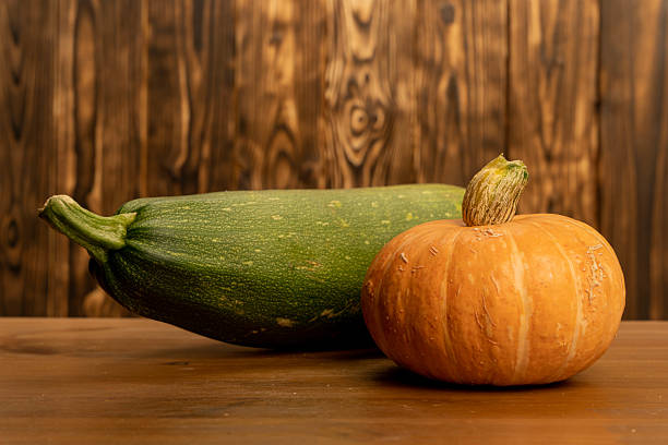 a yellow pattypan squash with green stem on white top view
