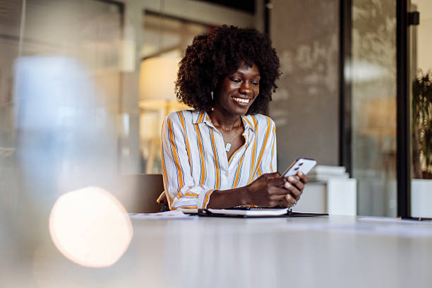 istock Smiling Businesswoman Using Smartphone in Modern Workplace Setting 2236408172
