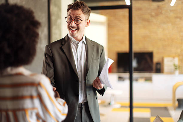 istock Business Professionals Conversing in a Modern Office Environment with Cheerful Disposition 2236408173