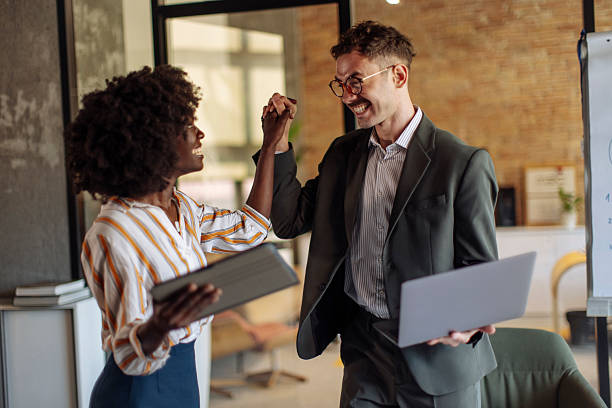istock Professional Coworkers Sharing Success During Collaborative Work in Office Environment 2236408201