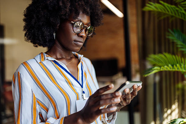 istock Focused Businesswoman Using Smartphone in Modern Office Environment 2236408214