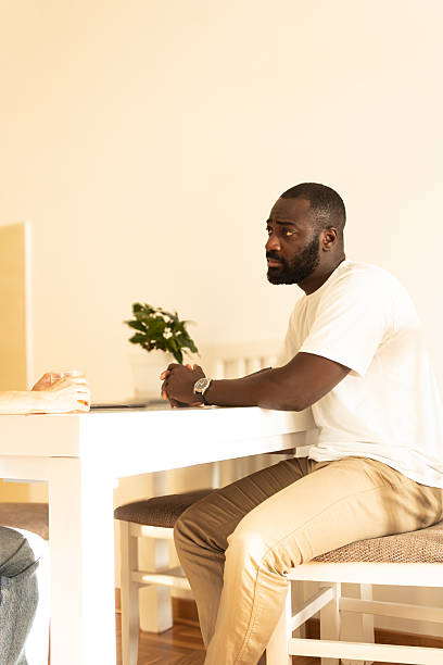 Concerned black man listening during serious discussion