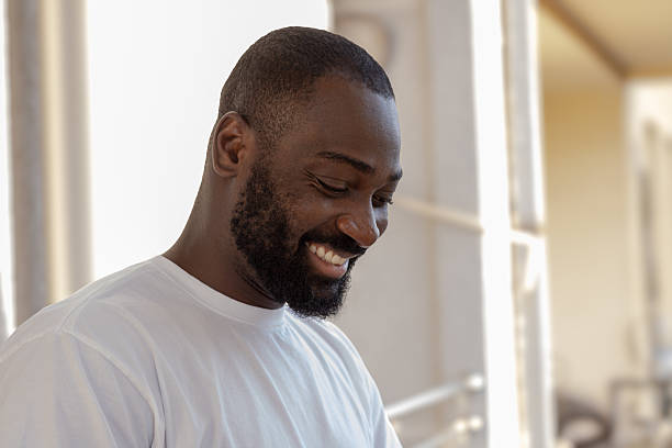 African american man smiling happily looking down
