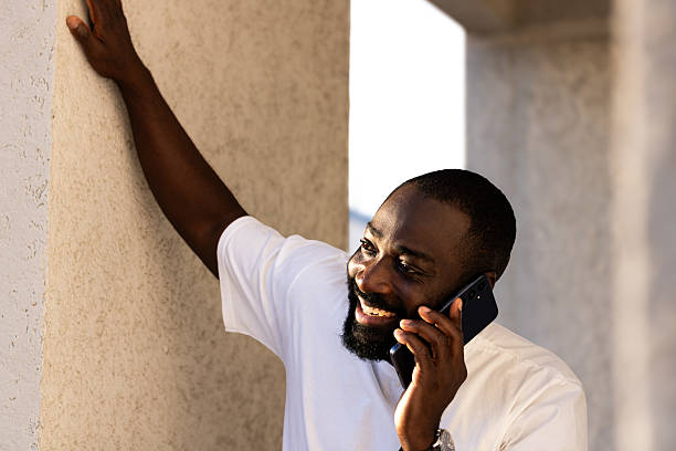 istock Happy man having phone conversation outdoors 2236408547