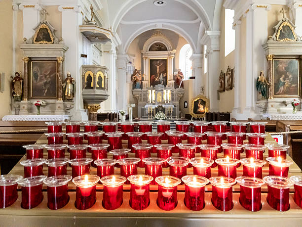 Votive candles burning on an altar in a Catholic church