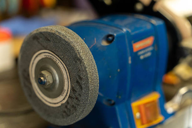 istock Grinding wheel spinning on bench grinder in workshop 2236412735