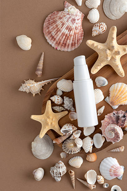 istock White cosmetic bottle with dispenser surrounded by seashells and starfish 2236414010
