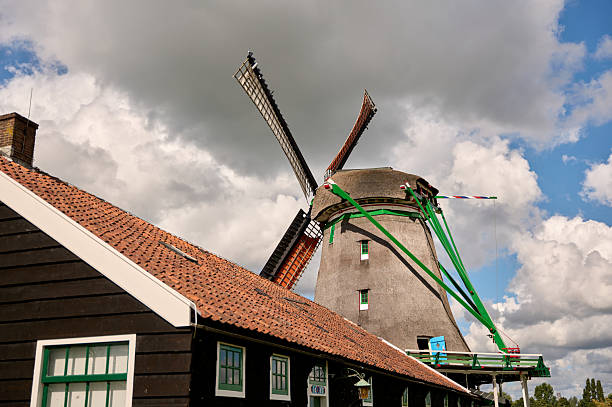 Zaanse schans windmill and traditional house under a dramatic cloudscape