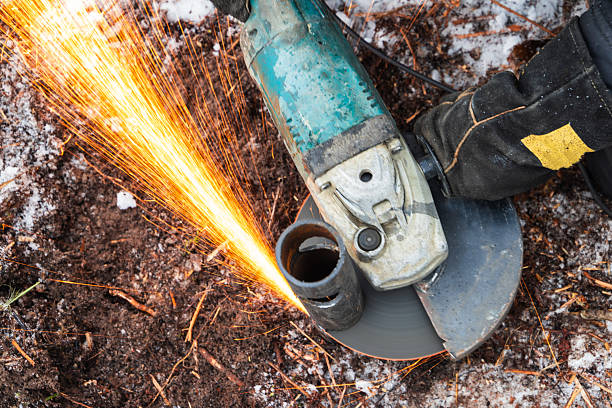 istock Angle grinder sparks as a worker cuts metal pipe outdoors 2236418273