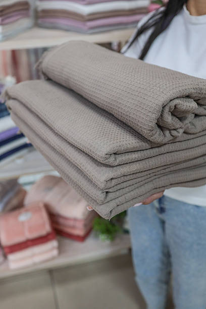 istock Woman holding folded waffle weave blankets 2236420340