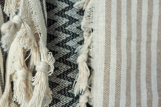 istock Close-up of textured fabric with tassels and various patterns. 2236422133