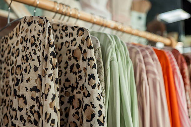 istock Clothes hanging on a rack in a clothing store 2236422147