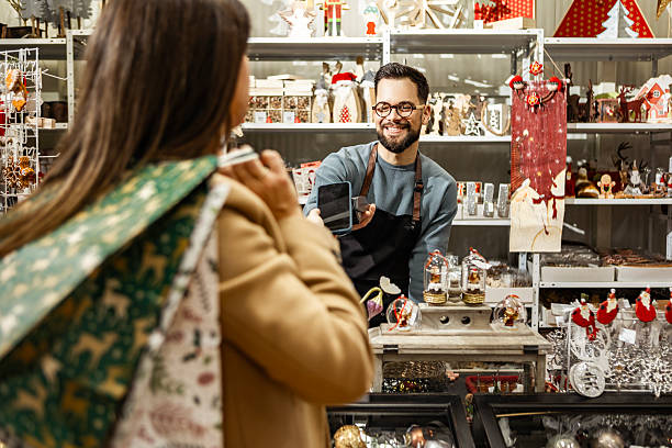 istock Smiling staff assisting customer in retail store 2236423539