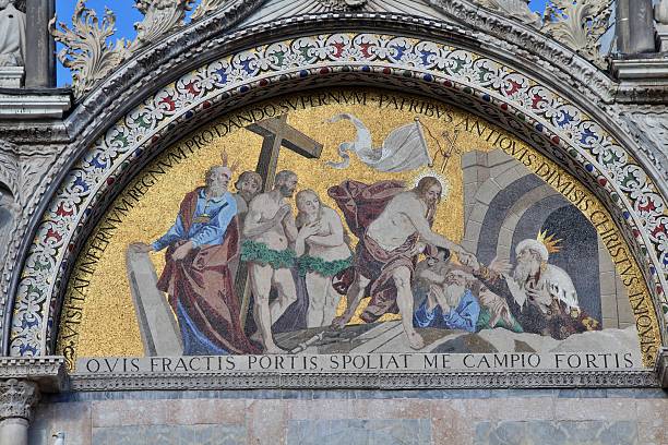 Low angle view of the ornate interior of St. Mark's Basilica in Venice, featuring stunning gold mosaics and architectural details.