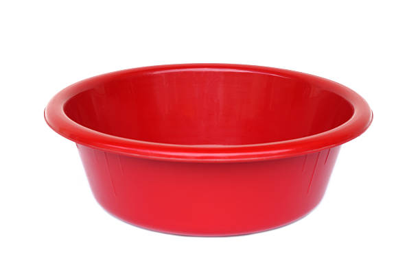 istock Bright red plastic basin isolated on white background. Household utility container used for washing clothes, cleaning, soaking items or food preparation. Durable, lightweight, and versatile daily tool 2236428894