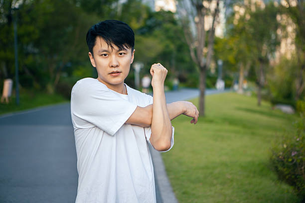 A young Asian man is preparing to exercise in the park