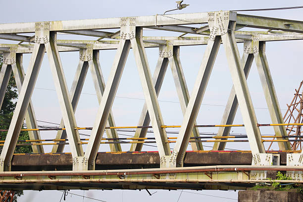 Old steel truss bridge structure with metal frame and visible rusty details outdoors