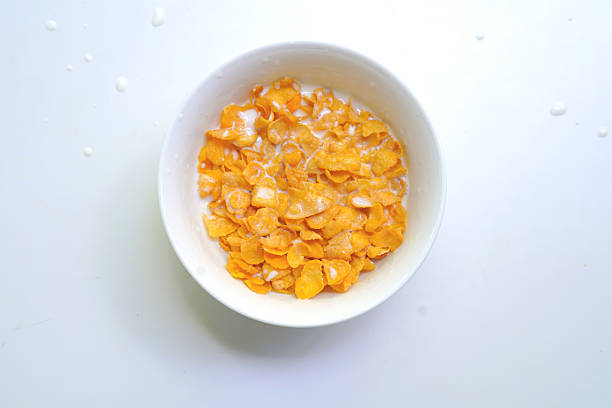 Corn flakes in a bowl on white background. Food Stock