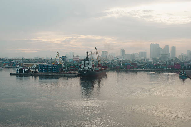 Manila, Philippines - July 22, 2019: Early in the morning, the container ship MV OCEAN ZENITH unloads its cargo at a commercial dock in Manila.
