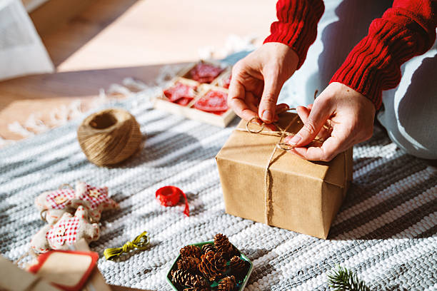 istock Wrapping a Christmas Gift with Kraft Paper and Twine 2236434515