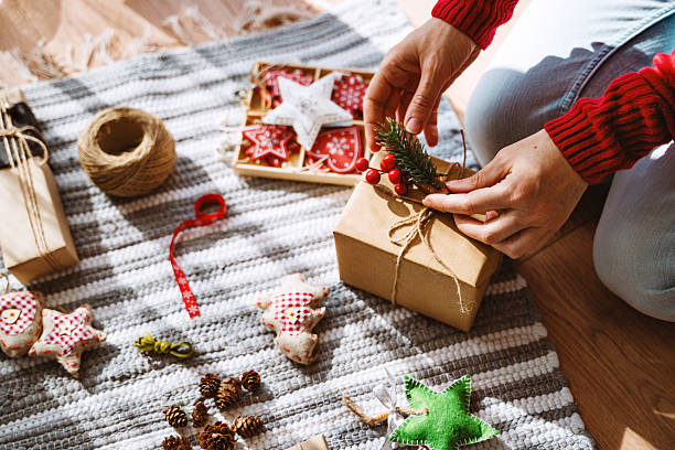istock Wrapping a Christmas Gift with Natural Decor in Cozy Setting 2236434527