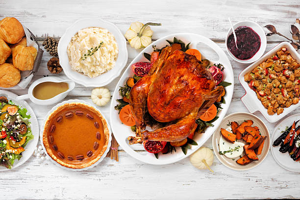 istock Thanksgiving turkey dinner. Above view table scene on a rustic white wood background. 2236438452