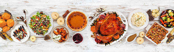 istock Thanksgiving turkey dinner. Top view table scene on a rustic white wood banner background. 2236438544