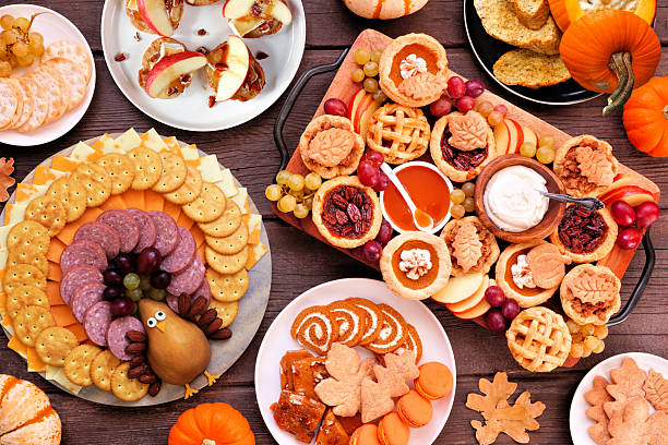 istock Thanksgiving appetizers, sweets and grazing boards. Overhead view table scene on a dark wood background. 2236438548