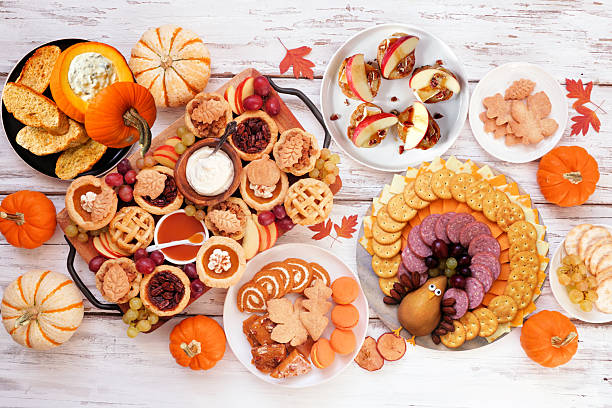 istock Thanksgiving appetizers, sweets and grazing boards. Top down view table scene on a white wood background. 2236438939