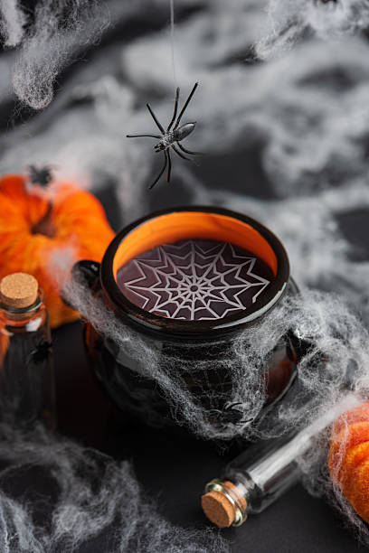 istock Halloween Cauldron with Pumpkins, Spiders and Cobwebs 2236444486