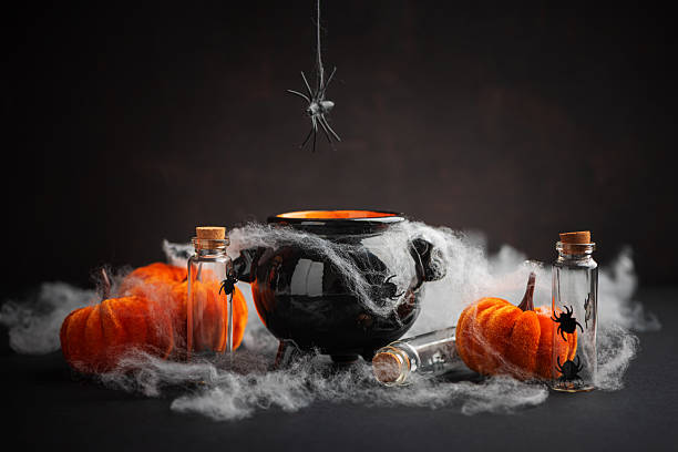 istock Halloween Cauldron with Pumpkins, Spiders and Cobwebs 2236444487