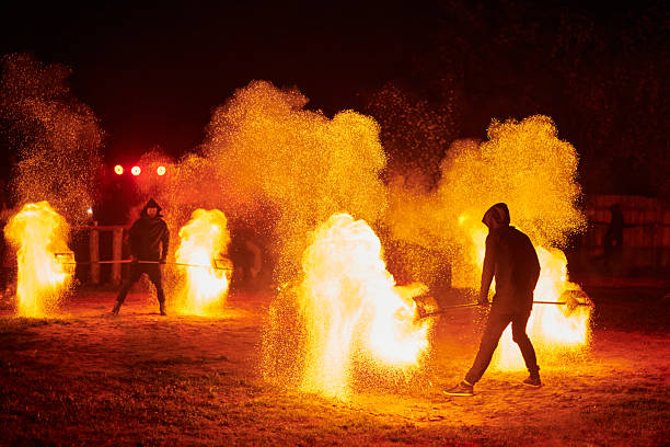 istock Silhouette of Two Fire Performers Creating Sparks Against Night field 2236447035