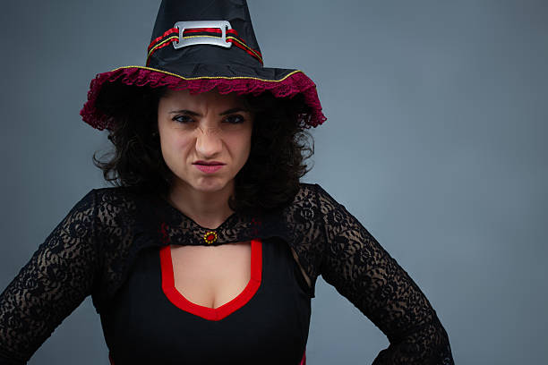 istock Angry witch in black and red costume for Halloween evil tricks. 2236448234