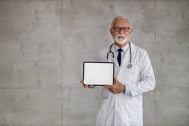 istock Experienced doctor holds blank tablet in a modern clinic during office hours 2236452673