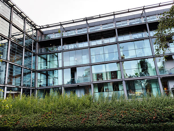 istock Modern building with glass facade surrounded by greenery in UK 2236461703