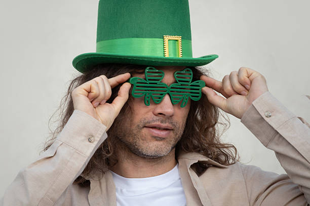 istock Man Wearing Shamrock Glasses and Green St. Patrick's Hat 2236465613