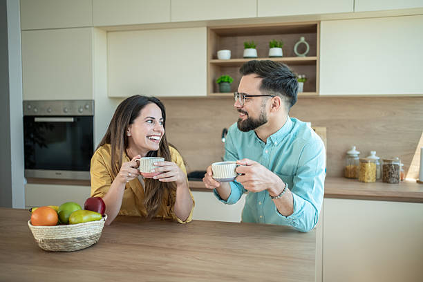 istock Happy couple enjoying coffee and conversation in kitchen 2236467909