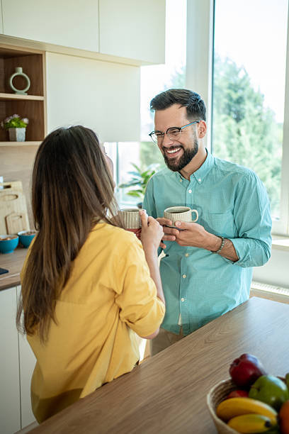 istock Happy couple enjoying coffee and conversation in kitchen 2236467950