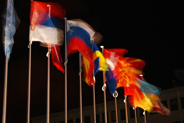 istock Row of waving national flags at night 2236468352