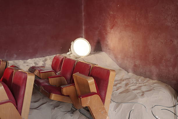 An Abandoned Cinema That Was Once Lively, Now Left Behind and Surrounded by Endless Sand Dunes